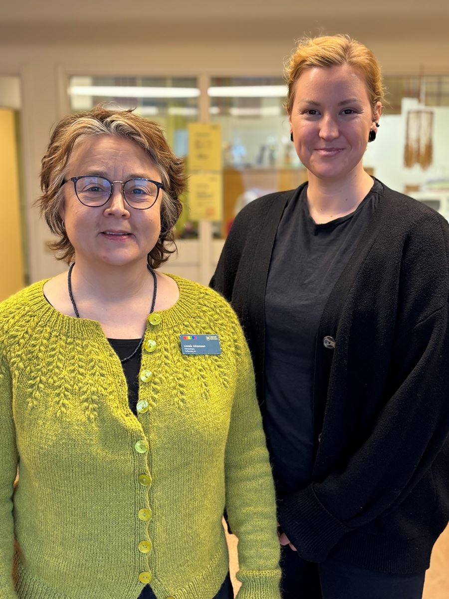 Yngre kvinnor ler och tittar in i kameran