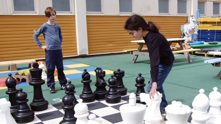 Barnen klurar ut bästa draget i schack.