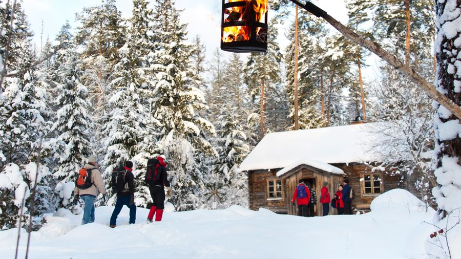 Vandrare anländer till Lunsentorpet som är inbäddat i snö.